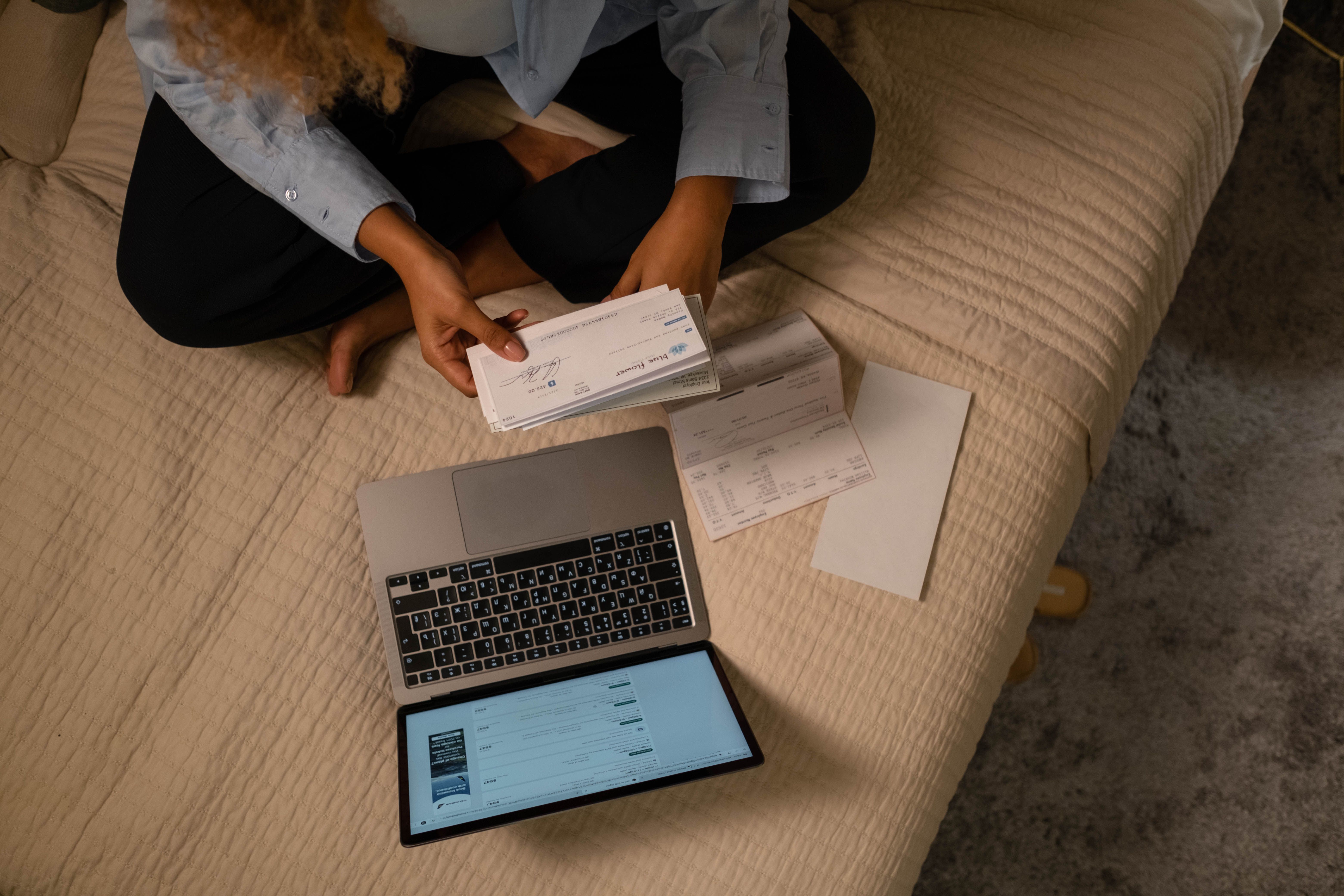Person checking a financial record before verifying unclaimed property
