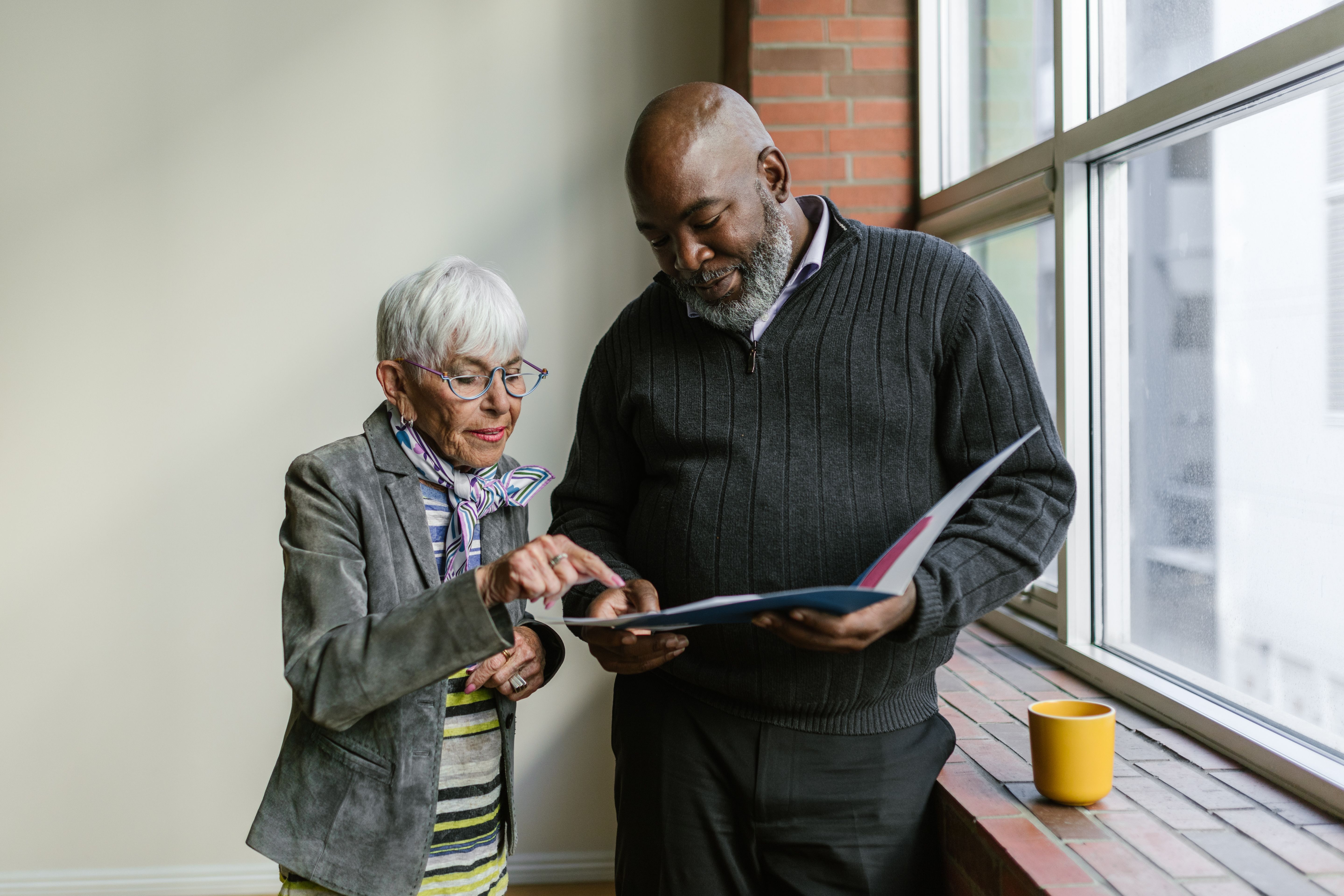 Senior person reviewing documents before an unclaimed money search